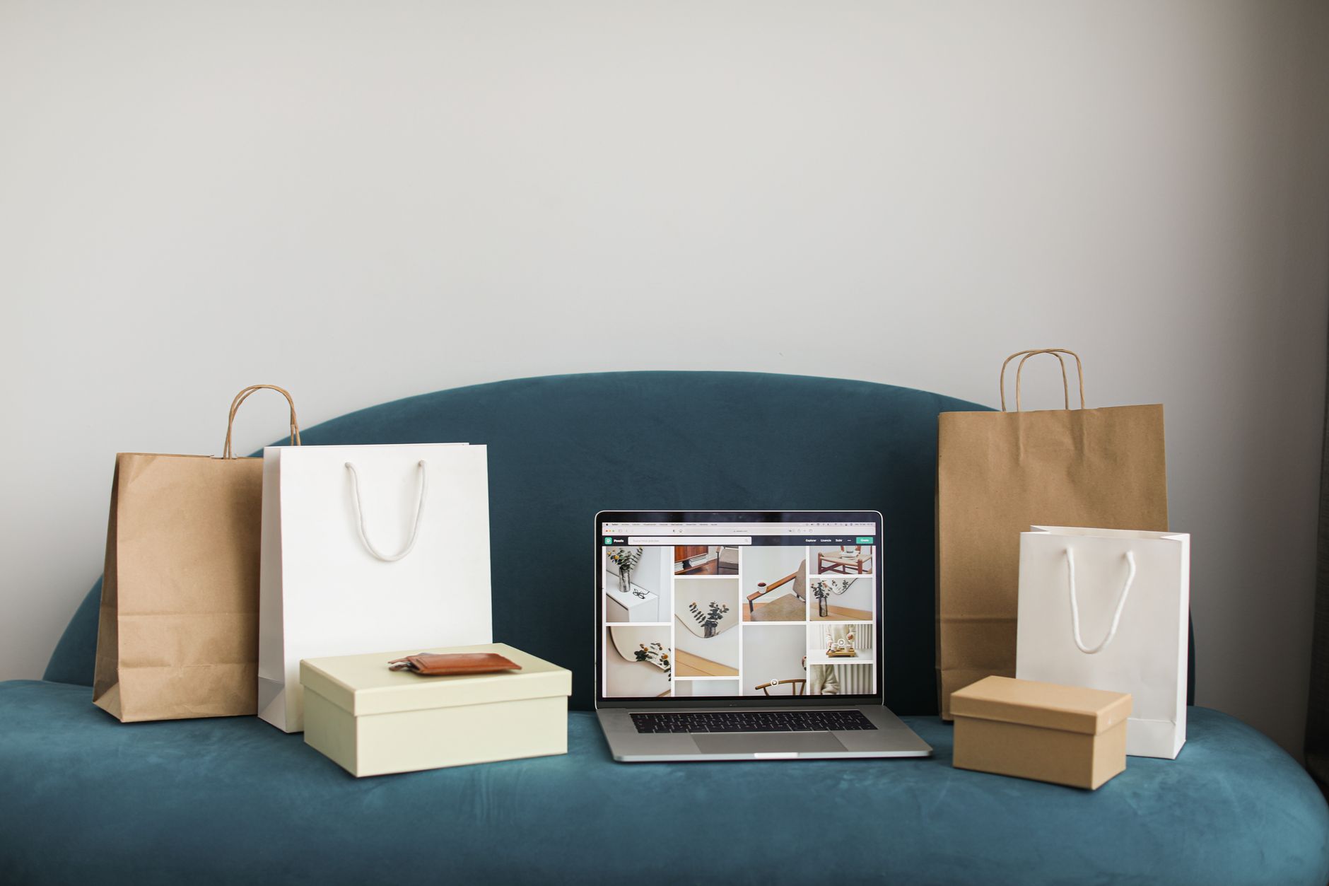 Laptop surrounded by shopping bags showing ecommerce and online shopping for Google Shopping Ads strategy